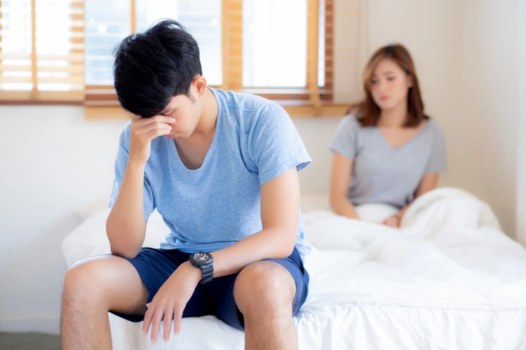 Man feeling depressed over his inability to perform in bed with his partner due to Erectile Dysfunction (ED) condition.