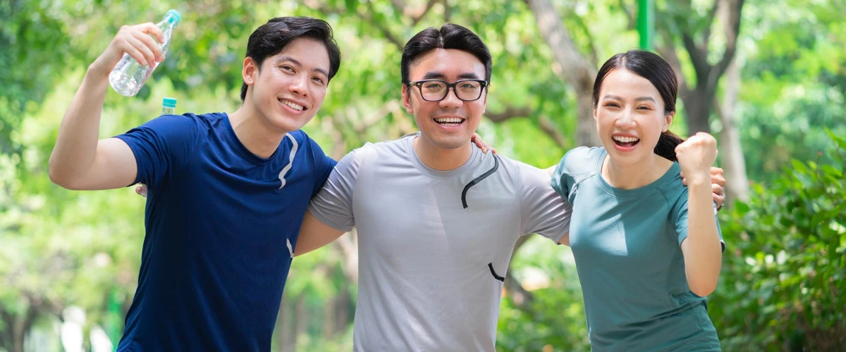 2 men and 1 woman feeling healthy and happy after going for a run together.